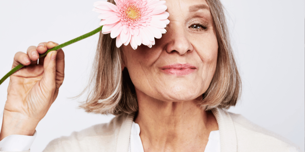 white background with flower holding her right hand Infront of her left eye