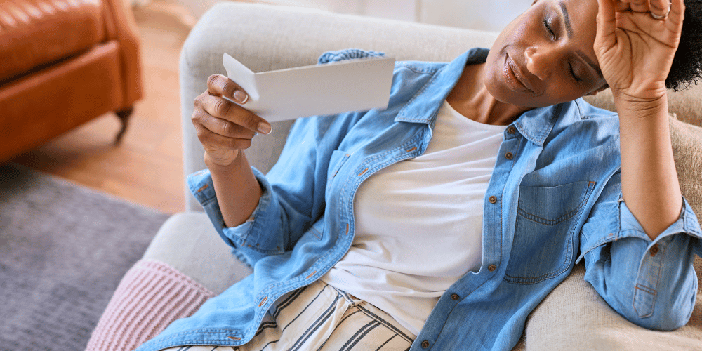 The image shows feeling a burning sensation. The person is sitting on a couch indoors.