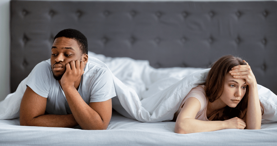 interracial couple in bed  experiencing disconnect due to libido loss