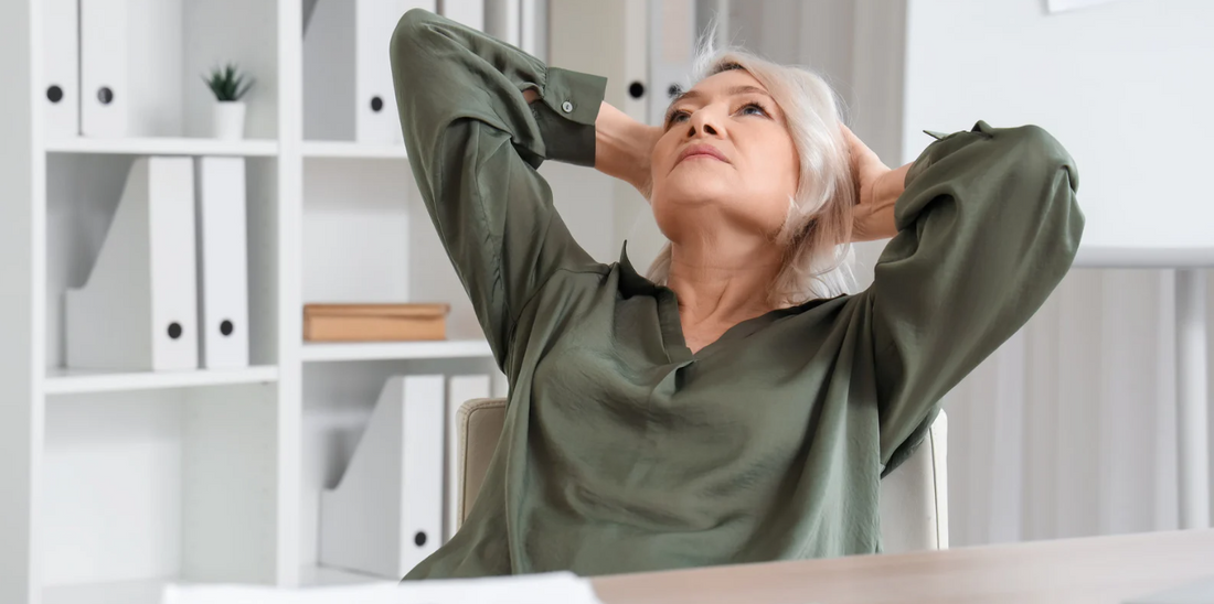 A woman with silver hair sits in an office setting