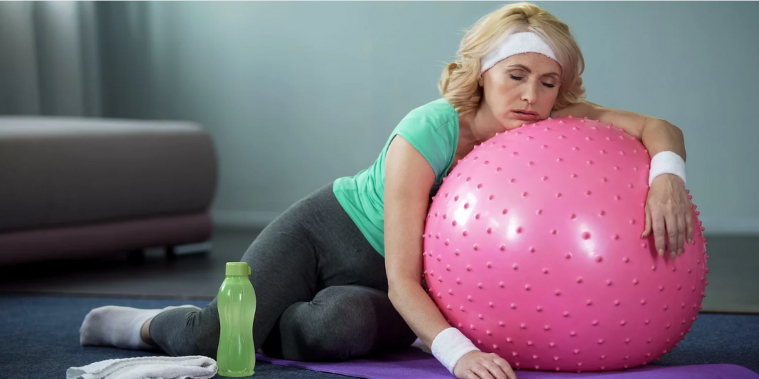 Woman sleeping on exercise ball.