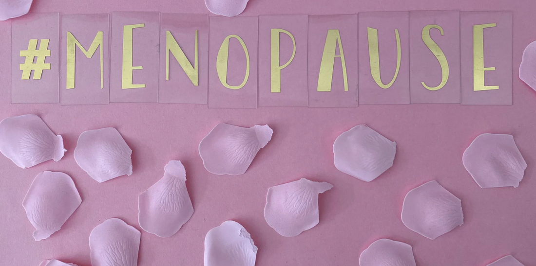 Menopause spelled with rose petals.
