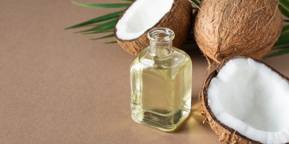 The image shows a glass jar containing a white substance and a white bowl with a brown substance in it. The tags for the image include bottle, coconut, and oil.