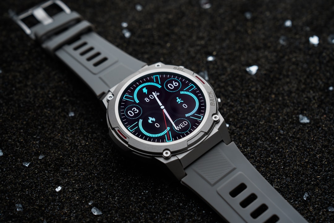 A watch sitting on top of a black surface