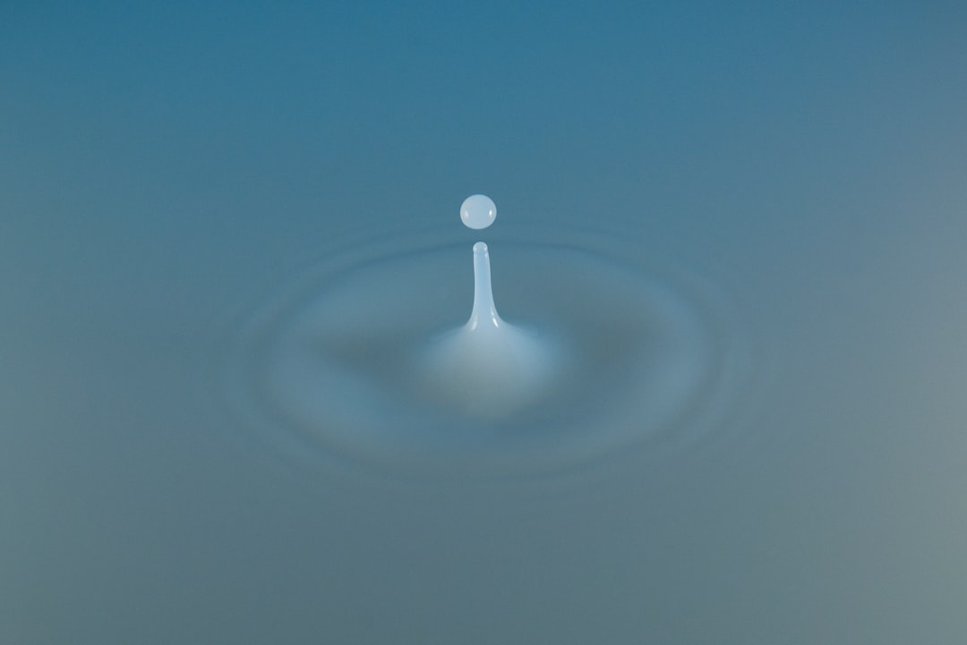 A picture of a drop of water on a blue background