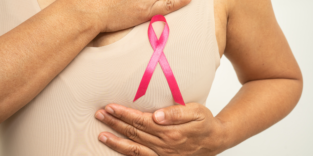 a woman with a pink ribbon on their chest