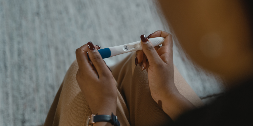 A woman holding a pregnancy test