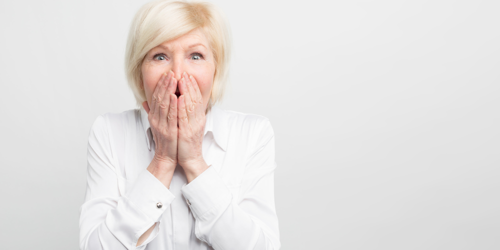 a woman covering her mouth