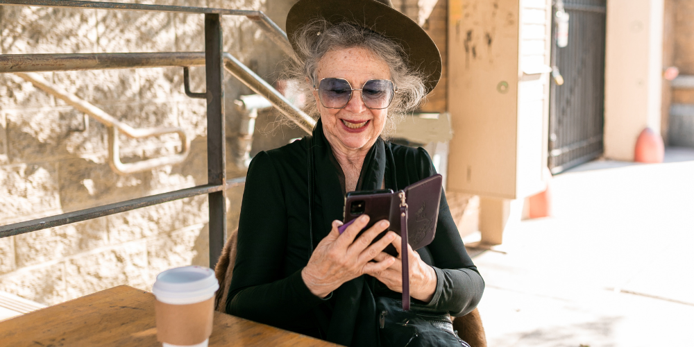 an old woman having a coffee outside