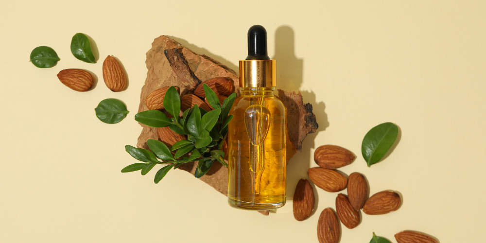 The image shows almond oil in a bottle.