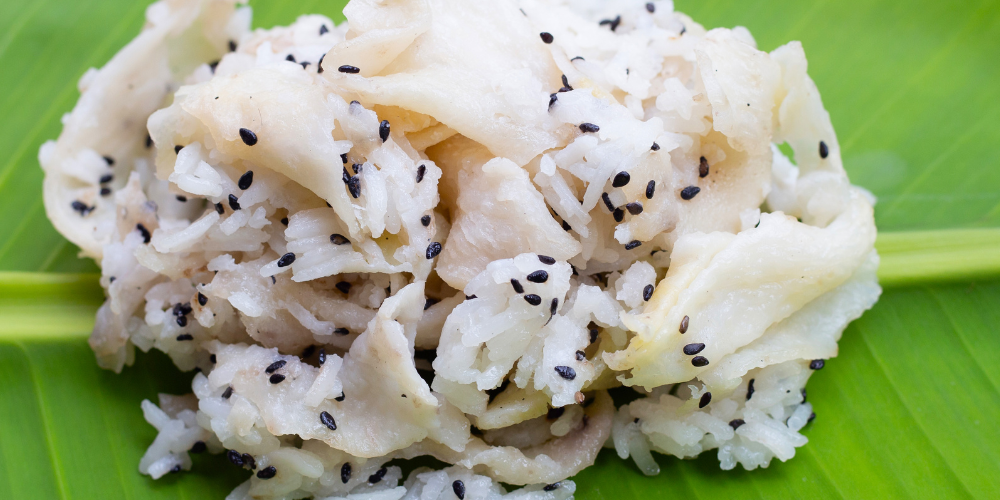 white food with black seeds on a leaf