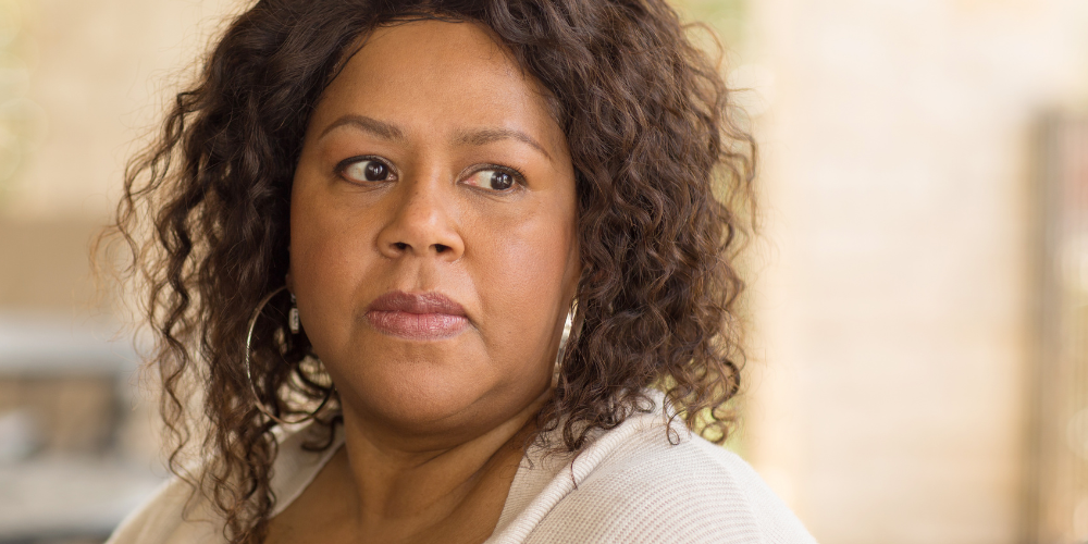 a woman indoors with curly hair