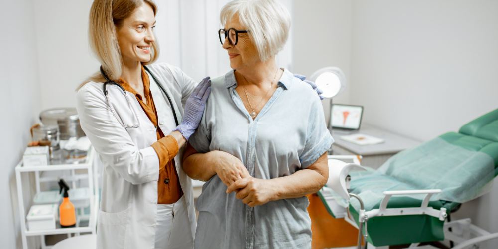 The image shows a doctor helping an old woman.