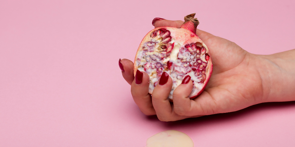 The image shows a person holding a fruit.