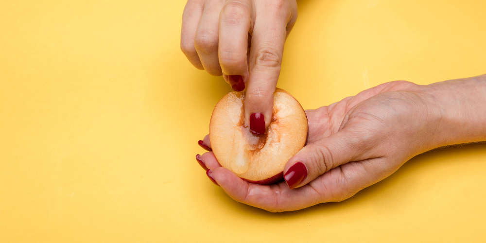 The image shows a person holding an apple.