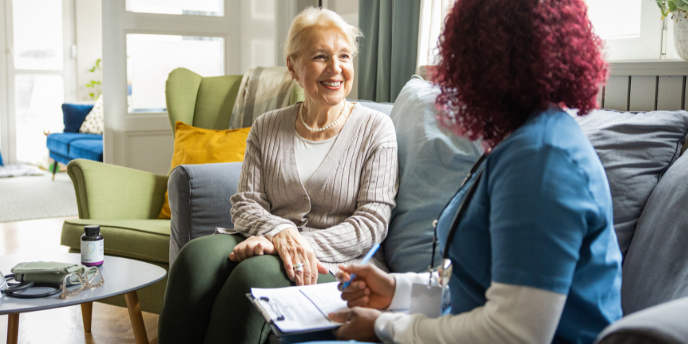 an old woman and a nurse talking