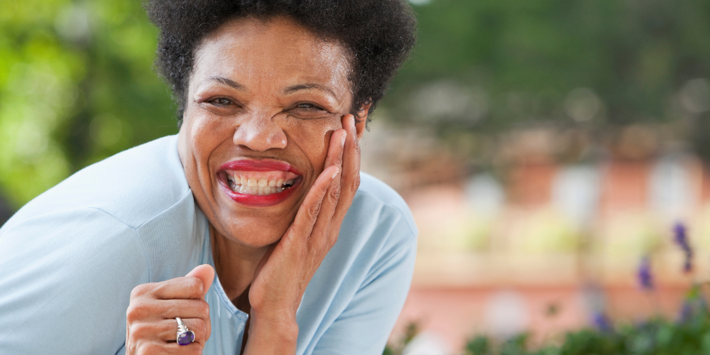 a woman smiling outdoors for a picture