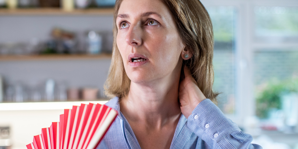 The image shows a woman holding a fan.