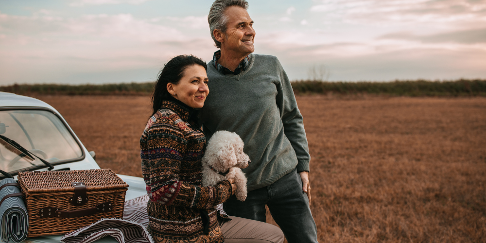 A couple with a dog outdoors