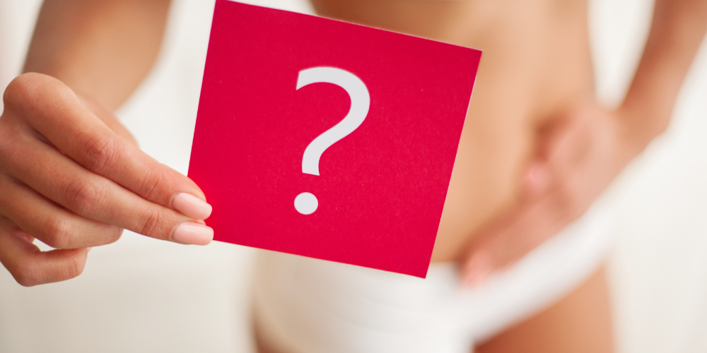 a woman holding a red paper with question mark