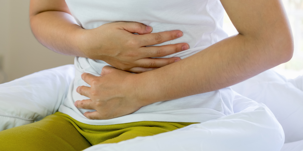 a person holding their stomach in pain