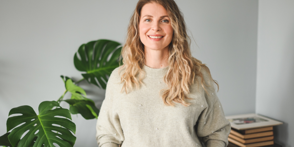 a woman with blonde hair smiling for a picture