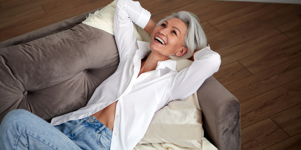 a woman laying comfortably on the couch