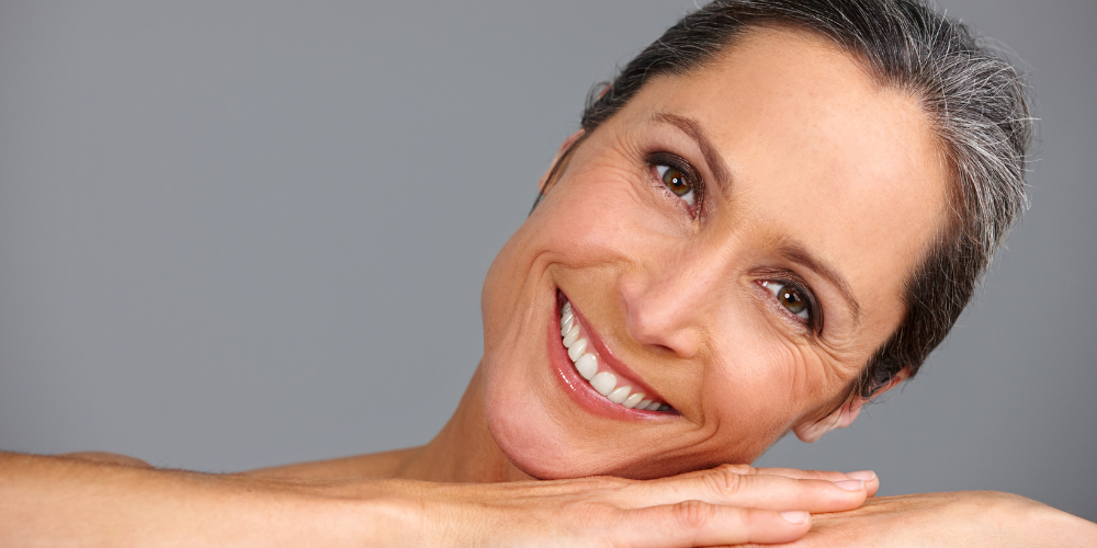 a woman posing for a picture and smiling