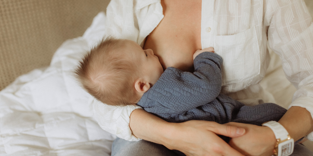 woman breastfeeds baby